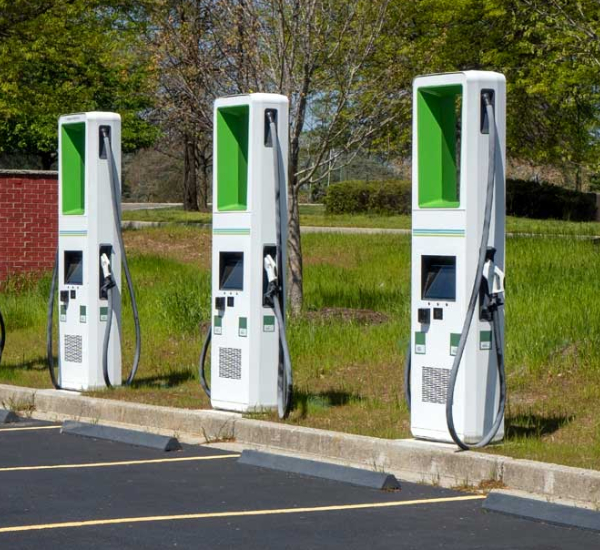 Newly installed EV charger with an electric car plugged in